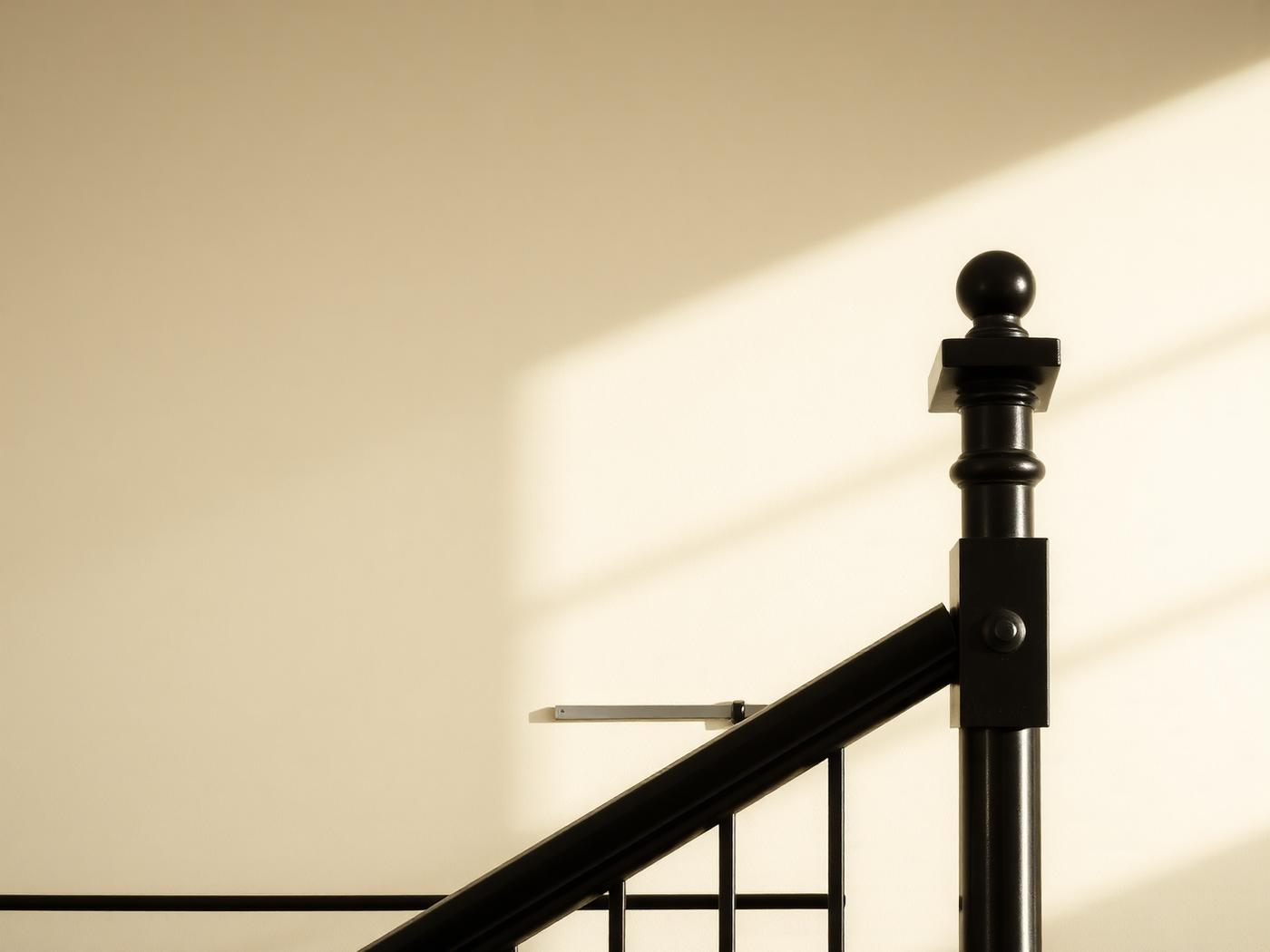 Close-up of a steel railing post and handrail junction